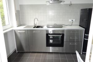 a kitchen with a sink and a stove at Kleine Wohlfühloase 2.0 in Heidelberg
