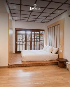 a bedroom with a large bed in a room at Lavana Villa by Raminten in Yogyakarta +8 photos