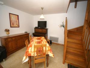 a dining room with a table and a television at Normandy Family Retreat in Brainville