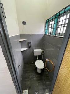 a bathroom with a white toilet in a stall at Epy Homestay Teluk Intan in Teluk Intan