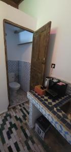 a bathroom with a toilet and a counter with a door at Dawya terrace in Fez
