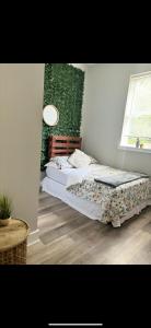 two beds in a room with a green wall at Full House or Rooms & private bath Stays- Diamond Street Beautiful Luxury Estates in Philadelphia