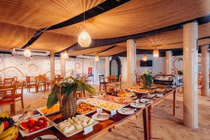 a buffet of food on a table in a room at Own Búzios Beach Hotel in Búzios