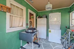 a kitchen with green walls and white appliances at Historic Cabin with Porch and Firepit 5 Minutes from Bryson City in Bryson City