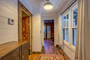 an empty hallway of a house with a window at Historic Cabin with Porch and Firepit 5 Minutes from Bryson City in Bryson City
