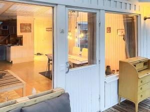 a room with a door and a table and a dining room at Countryside retreat for 4 guests in Skånes Fagerhult