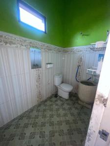 a bathroom with a toilet and a sink and a window at mas dylan homestay in Bromo +29 photos