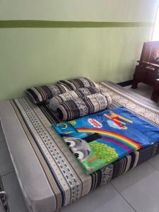 a bed with a panda blanket on top of it at mas dylan homestay in Probolinggo +32 photos