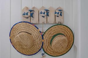 two baskets are hanging on a wall at Liana One Coastal Mission Vibe One Bedroom in Mission Beach