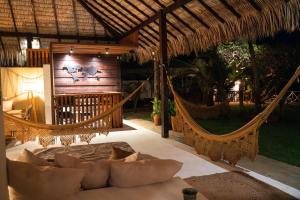 a room with two hammocks in a resort at Santa Maria Atins in Atins