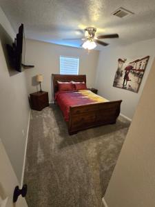 a bedroom with a bed and a ceiling fan at Luxurious Tomball Getaway in Tomball +59 photos