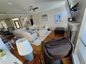 a living room with a white couch and a fireplace at Luxurious Tomball Getaway in Tomball