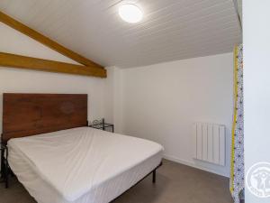 une chambre avec un lit blanc dans une pièce dans l'établissement Studio cosy avec terrasse en campagne, proche Nantes - FR-1-622-109, à Saint-Christophe-la-Couperie