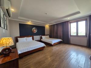 Postel nebo postele na pokoji v ubytování CAMY Hotel Vung Tau
