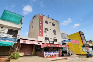 a building with a sign on the side of it at Hotel O HM & Restaurant in Begās