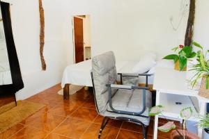 a living room with a chair and a bed at Ozen Freediving Hostel in General Luna +23 photos