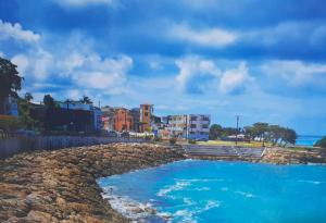 a large pool of blue water on a beach at BGF Location in Anse-Bertrand