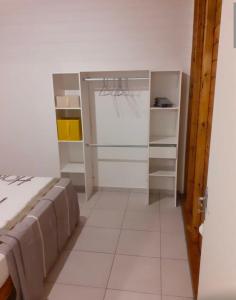 a small room with a bed and a closet at BGF Location in Anse-Bertrand