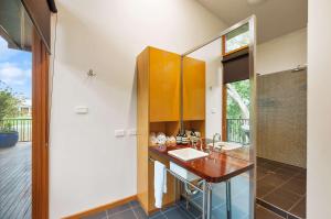 a bathroom with a counter and a sink at Elements - Echuca Holiday Homes in Moama