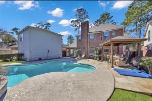 a swimming pool in the backyard of a house at Luxurious Tomball Getaway in Tomball