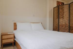 Postel nebo postele na pokoji v ubytování Boléro Homestay I 鄰近花園夜市