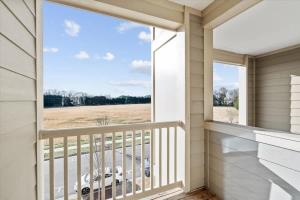a balcony with a view of a car outside at Upscale 2BR King Suite Mins to Uptown Charlotte in Charlotte