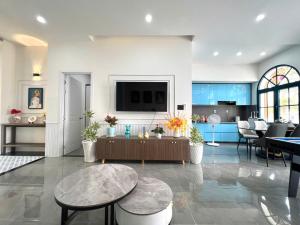 a living room with a tv on a wall at NOVA WORLD PHAN THIẾT - An VILLA in Bình Tú