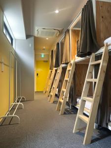 a row of bunk beds in a room at Hostel Hangout Best Value Near Kuromon Market & Namba in Osaka