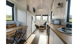a kitchen in a tiny house with a counter top at Little Lady Cabin by Tiny Away in Rylstone