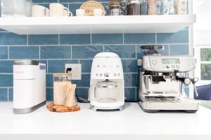 a kitchen counter with a mixer and a coffee maker at West Palm Beach Elegant 5BR with Hot Tub and Fire Pit Near Beach in West Palm Beach +71 photos