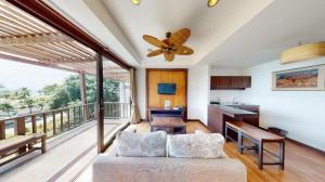 a living room with a couch and a ceiling fan at Maryoo Samui Hotel in Chaweng +99 photos