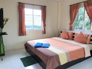 a bedroom with a bed with two blue pillows on it at Sea Beach Koh Larn 1 in Ko Larn +139 photos
