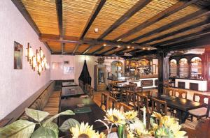 a dining room with tables and chairs in a restaurant at Hotel Al Poggio in Sestola