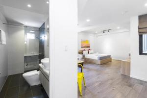 a bathroom with a sink and a toilet in a room at OPOX Nha Trang in Nha Trang +66 photos