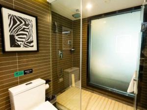 a bathroom with a glass shower and a toilet at Xana Hotelle· Wulumuqi High Speed Railway Station Baonengcheng in Ürümqi +152 photos