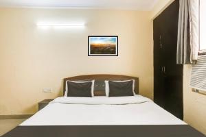 Postel nebo postele na pokoji v ubytování Hotel O Happy Residency