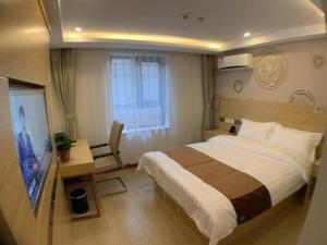 a hotel room with a bed and a television at Shell Hotel Beijing Fangshan District Chengguan Metro Station in Fangshan