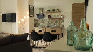 a living room with a table with a glass vase on it at maison de vacances locquirec in Locquirec +9 photos