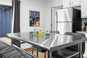 a kitchen with a stainless steel table and a refrigerator at Experience the Unique Re-Nu Shipping Container #3 in Louisville