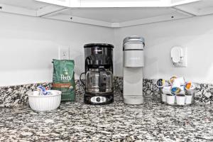 a kitchen counter with a coffee maker and a blender at Experience the Unique Re-Nu Shipping Container #3 in Louisville
