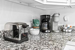 a kitchen counter with a toaster and a coffee maker at Experience the Unique Re-Nu Shipping Container #3 in Louisville