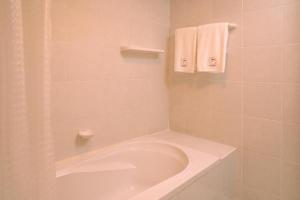 a white bathroom with a tub and a sink at The Mansion Pakchong in Mu Si +38 photos