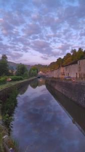 a body of water with buildings and houses on it at Chez Alain in Fontenoy-le-Château