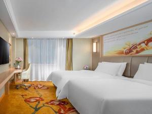 a hotel room with a large bed and a desk at Vienna Hotel Anhui Huainan Railway Station in Huainan