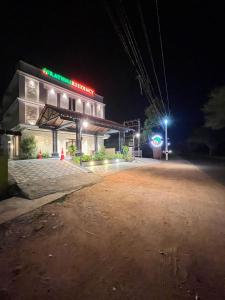 a gas station is lit up at night at Rathna Residency in Tiruppattūr
