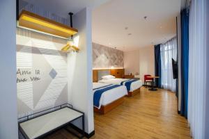 Postel nebo postele na pokoji v ubytování Borrman Hotel Shaoguan Nanxiong Rt-Mart + 37 fotografií