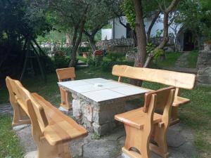 a picnic table and benches with a table and chairs at KATY&MLADEN in Baška