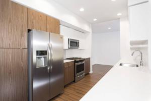 a kitchen with a stainless steel refrigerator and a stove at Verve Mountain View in Mountain View