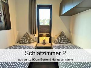 a small room with two beds and a window at Casa-MiU am Wasser - Olburgen - perfekt für Familien - mit Freibad, Sauna, Restaurant und Spielplatz in Olburgen +77 photos