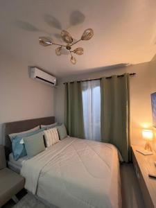 a bedroom with a bed and a ceiling fan at The Purrfect Stay in Lapu Lapu City +39 photos